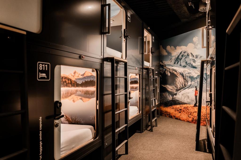 Row of compact sleeping berths along a lit corridor