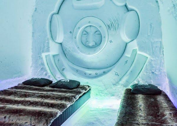 Snow room with a carved wall relief and a bed raised on a snow platform
