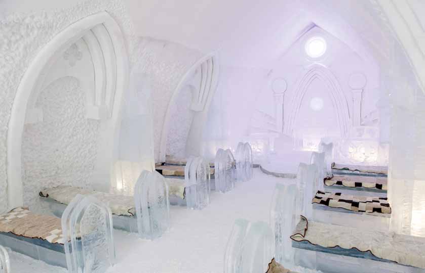 Snow corridor with carved walls and lamps set into blocks of ice